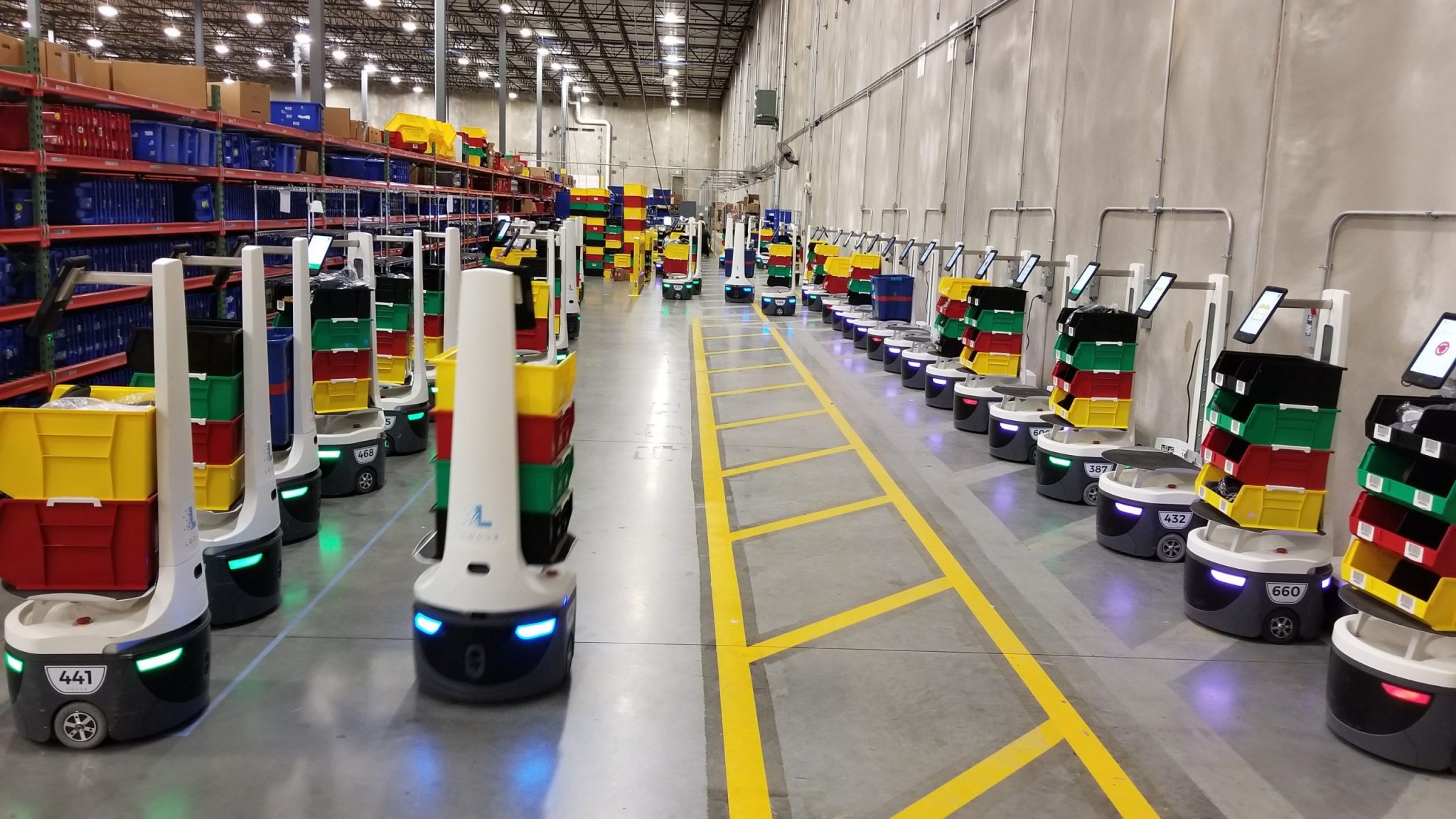 Locus robots lined up in a warehouse.